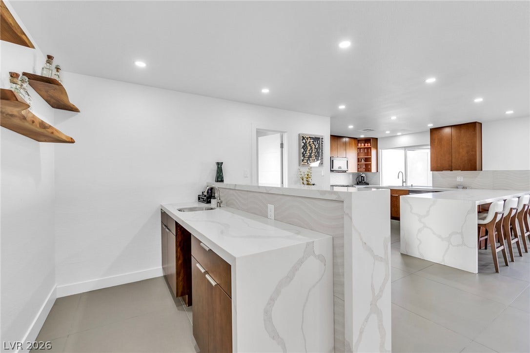 4170 Sheppard Drive, Las Vegas, NV 89121 Gleaming stone countertops and modern open spaces create a sleek culinary setting.