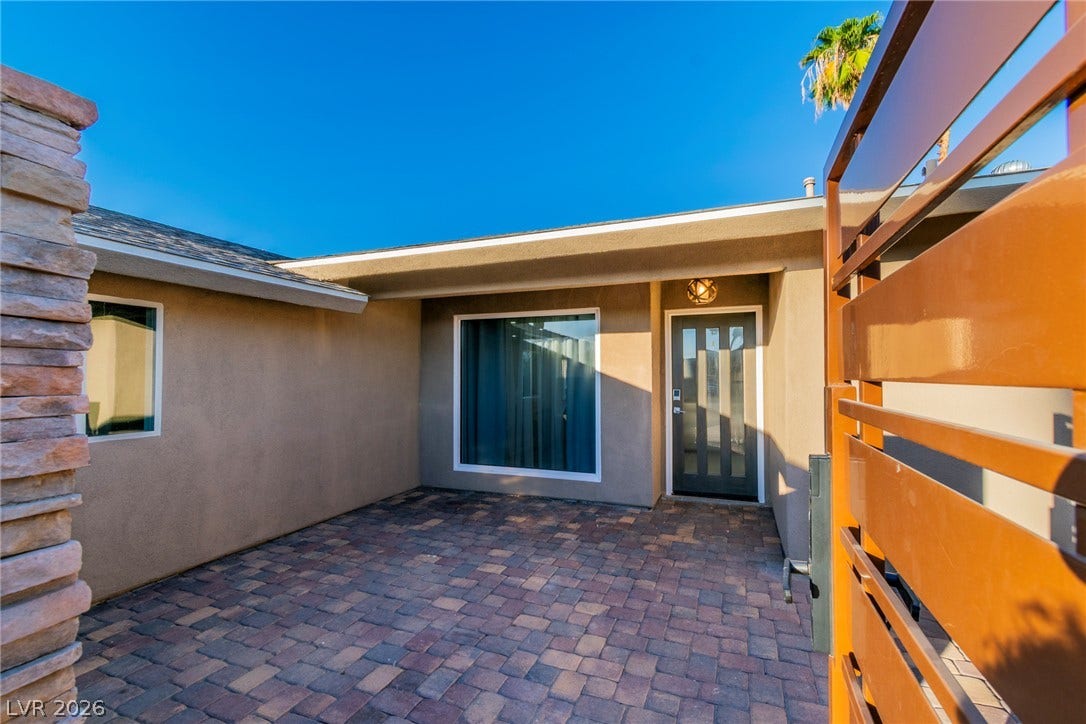 4170 Sheppard Drive, Las Vegas, NV 89121 An inviting gated entry patio paved with classic brick-style stones leads to the front door.