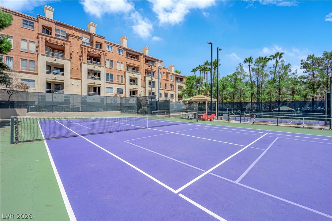 220 E Flamingo Road, #117, Las Vegas, NV 89169 Fenced courts provide recreational play space set against towering residential architecture.