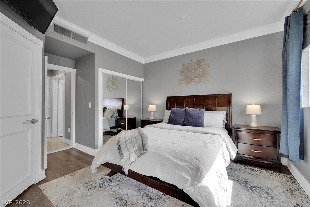 220 E Flamingo Road, #117, Las Vegas, NV 89169 Crisp crown molding and durable wood floors elevate this inviting secondary bedroom.