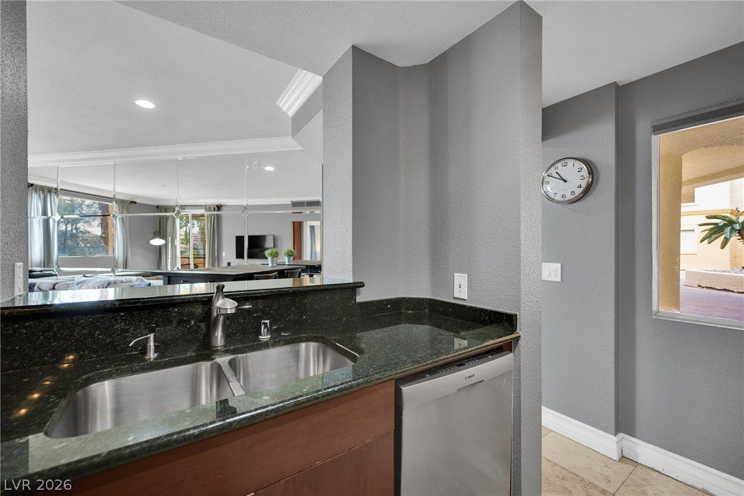 220 E Flamingo Road, #117, Las Vegas, NV 89169 Polished granite countertops and stainless steel appliances elevate this modern kitchen preparation space.