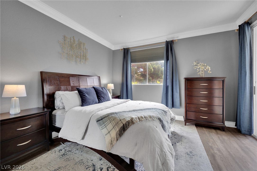 220 E Flamingo Road, #117, Las Vegas, NV 89169 Elegant crown molding and rich wood-texture flooring define this comfortable, light-filled bedroom space.
