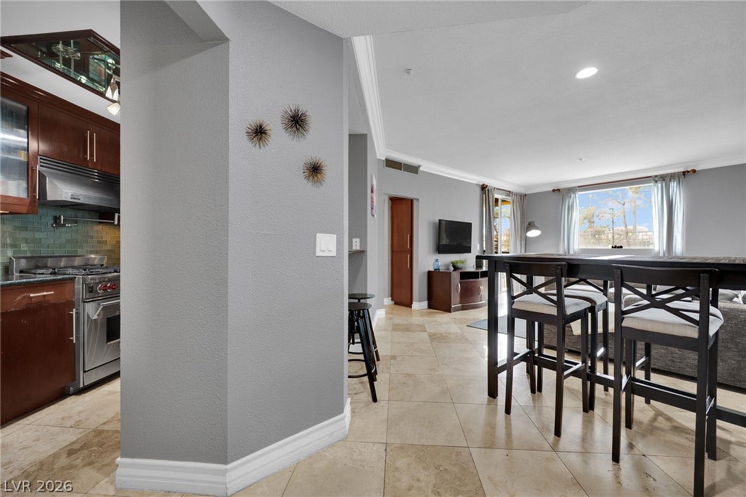 220 E Flamingo Road, #117, Las Vegas, NV 89169 An open floorplan seamlessly connects the functional kitchen space to the tiled dining area.
