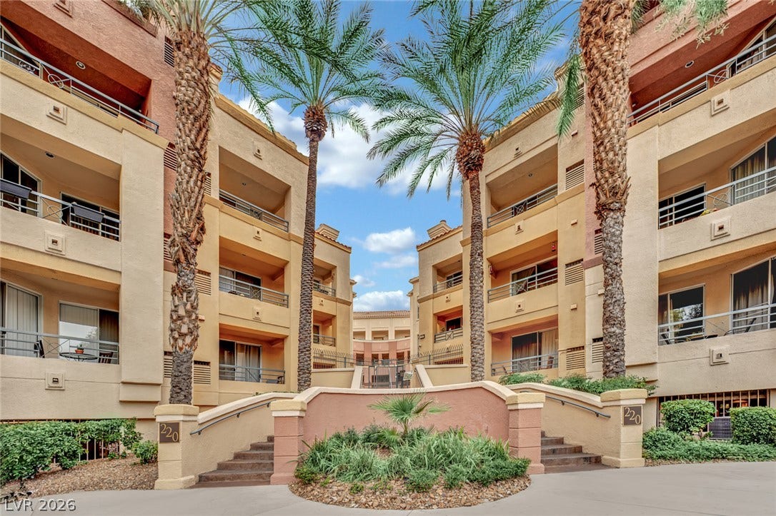 220 E Flamingo Road, #117, Las Vegas, NV 89169 Palm trees frame the multi-level stucco architecture of this courtyard entrance.
