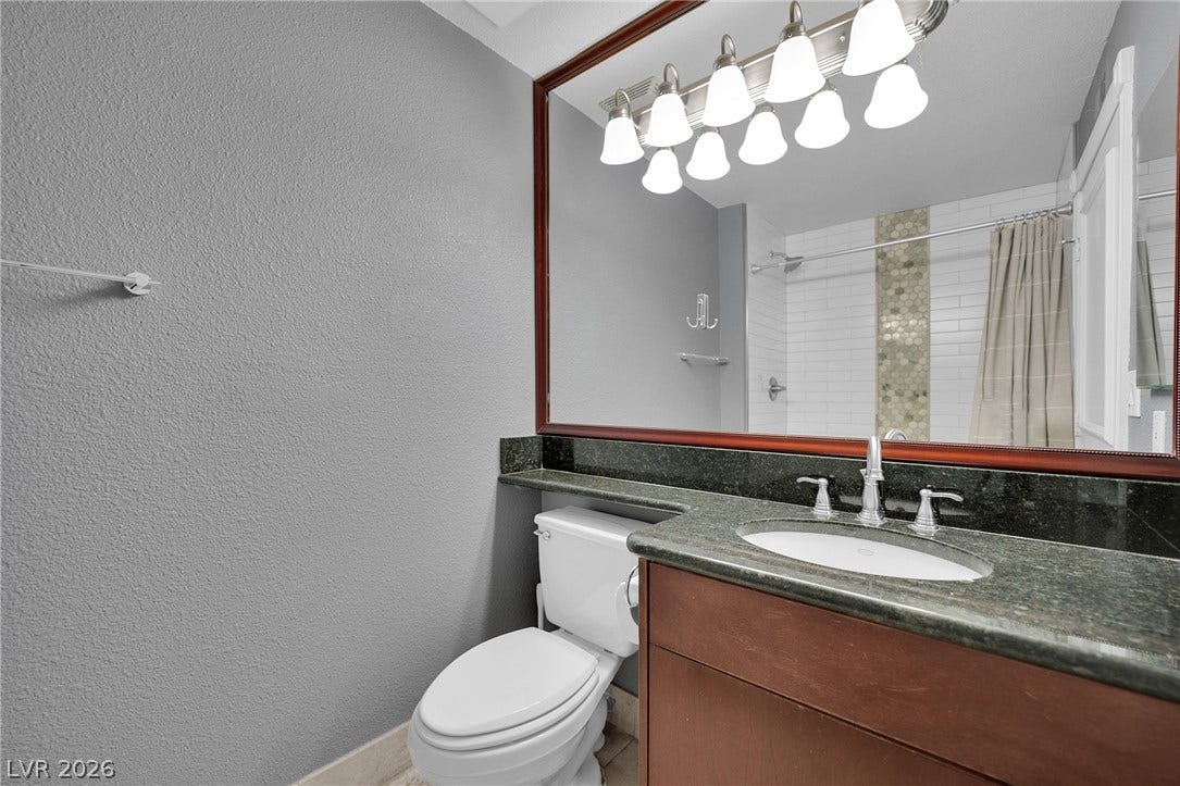 220 E Flamingo Road, #117, Las Vegas, NV 89169 Polished stone counters and a large framed mirror elevate this well-appointed bathroom space.