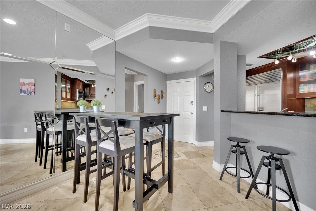 220 E Flamingo Road, #117, Las Vegas, NV 89169 Elegant crown molding and classic tile flooring enhance this open-concept dining area.