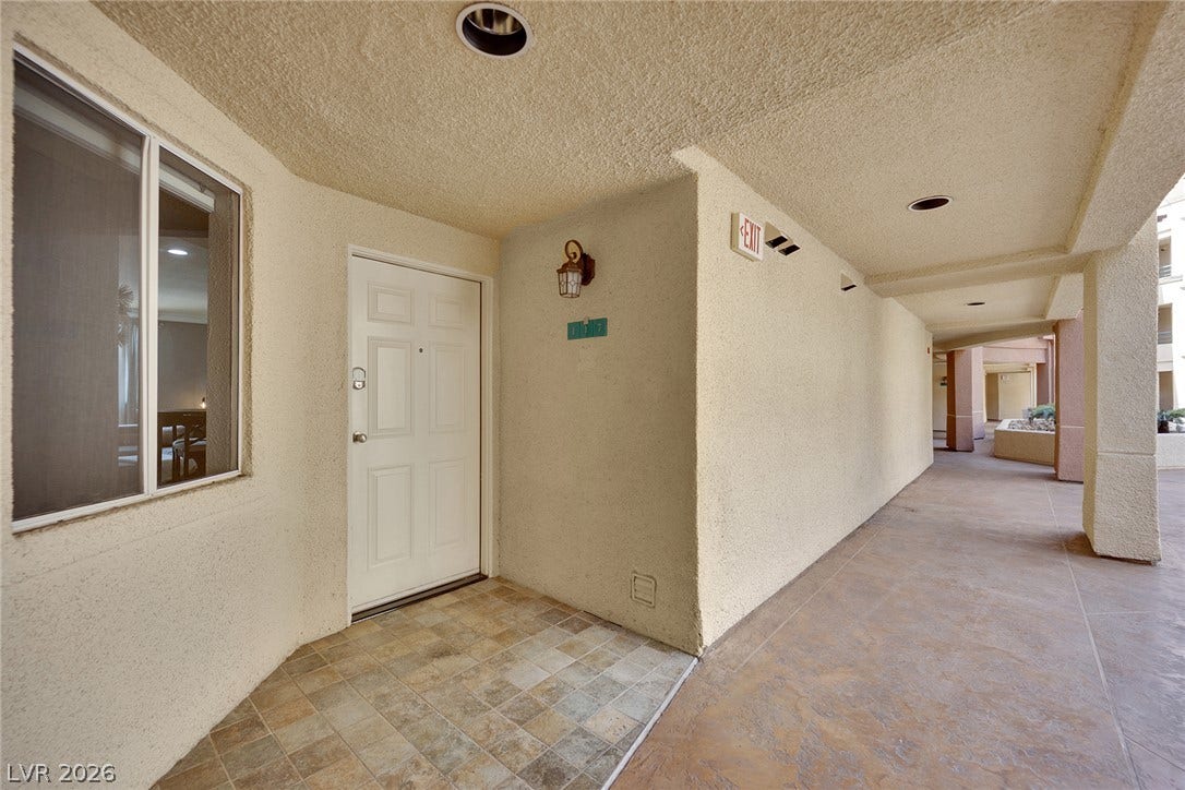 220 E Flamingo Road, #117, Las Vegas, NV 89169 A sheltered entryway with tiled flooring leads down a covered exterior corridor.