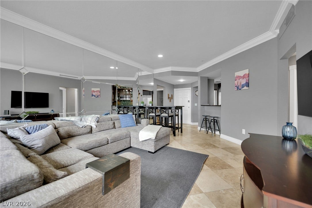 220 E Flamingo Road, #117, Las Vegas, NV 89169 Polished tile flooring and detailed crown molding enhance this airy, open-concept living space.