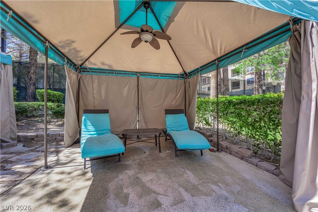 220 E Flamingo Road, #117, Las Vegas, NV 89169 An inviting shaded cabana offers a private stone patio retreat nestled alongside mature landscaping.