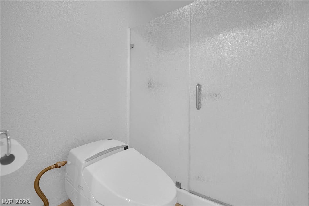 220 E Flamingo Road, #117, Las Vegas, NV 89169 A frosted glass door secures the walk-in shower adjacent to a modern toilet.