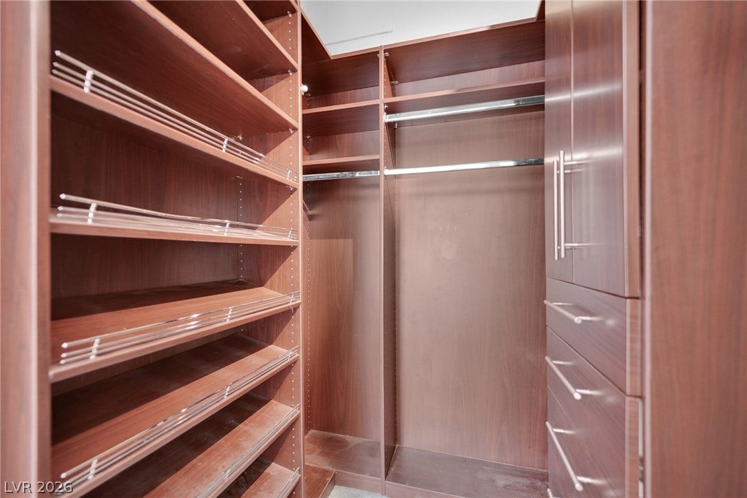 220 E Flamingo Road, #117, Las Vegas, NV 89169 Custom wood shelving and integrated drawers maximize storage efficiency in this walk-in closet.
