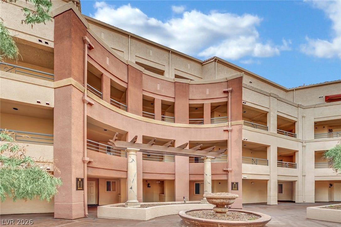 220 E Flamingo Road, #117, Las Vegas, NV 89169 Multi-level stucco architecture frames a central courtyard complete with a classical fountain and trellis entryway.