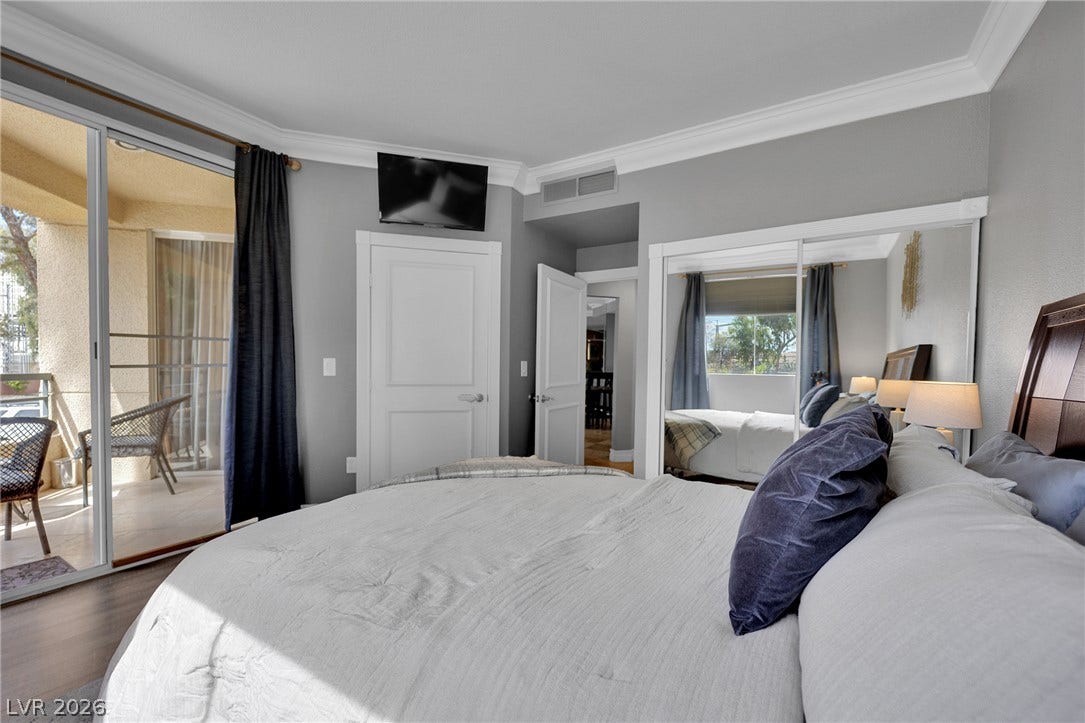 220 E Flamingo Road, #117, Las Vegas, NV 89169 Sliding glass doors open from the bedroom directly onto a private balcony.