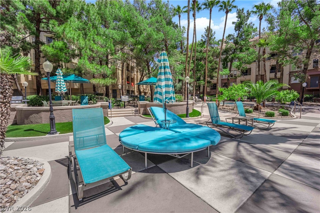 220 E Flamingo Road, #117, Las Vegas, NV 89169 Lush tropical landscaping and concrete pathways surround the relaxed outdoor community lounge areas.