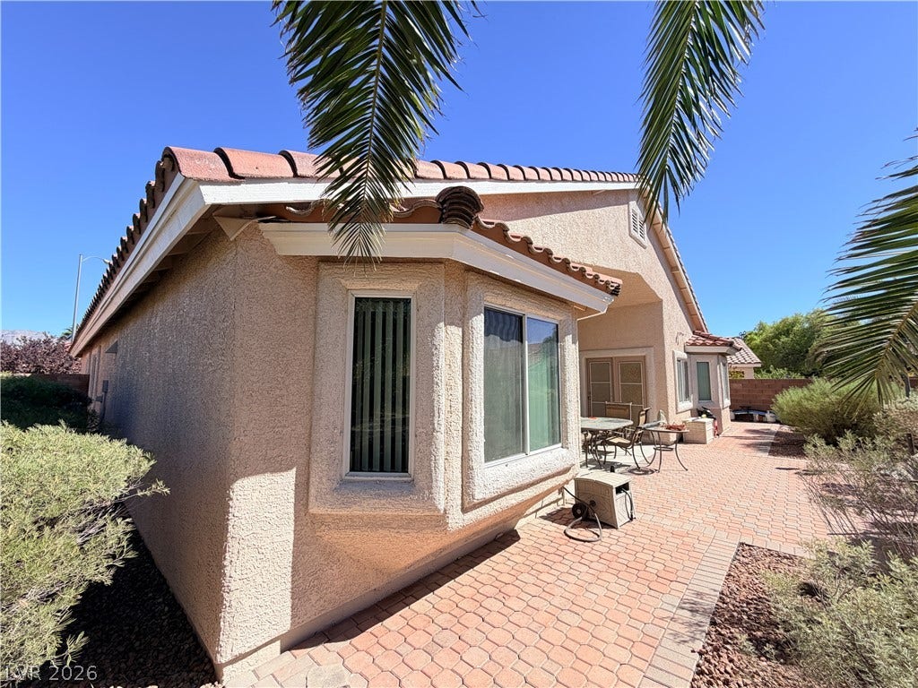3917 Robin Knot Court, North Las Vegas, NV 89084 A spacious brick paver patio lines the exterior of this single-story stucco home.