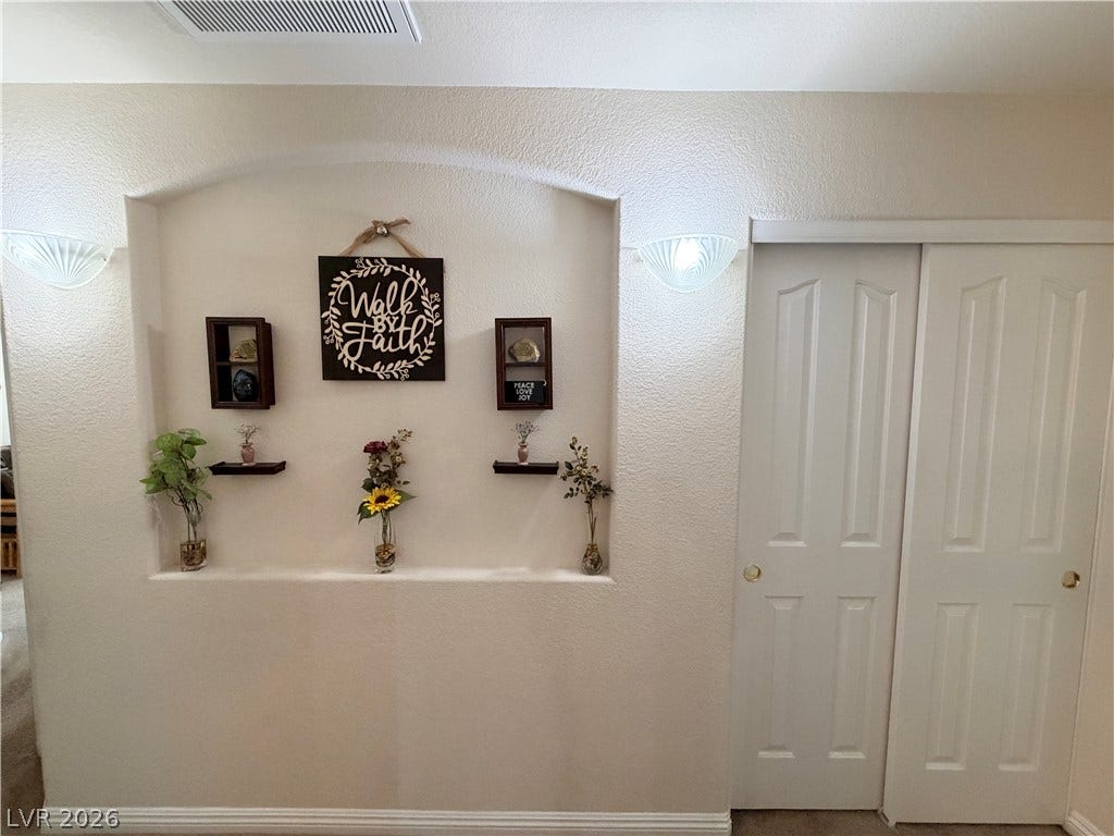 3917 Robin Knot Court, North Las Vegas, NV 89084 An arched display niche wall and classic sliding closet doors define this entryway.
