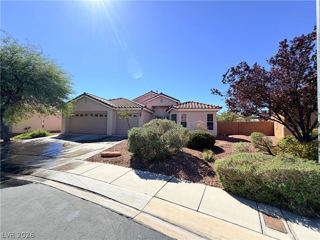 3917 Robin Knot Court, North Las Vegas, NV 89084 Tile roofing and desert-friendly landscaping highlight this classic suburban facade under clear blue skies.