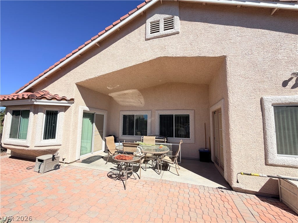 3917 Robin Knot Court, North Las Vegas, NV 89084 An inviting covered patio opens onto a spacious paver terrace under sunny skies.