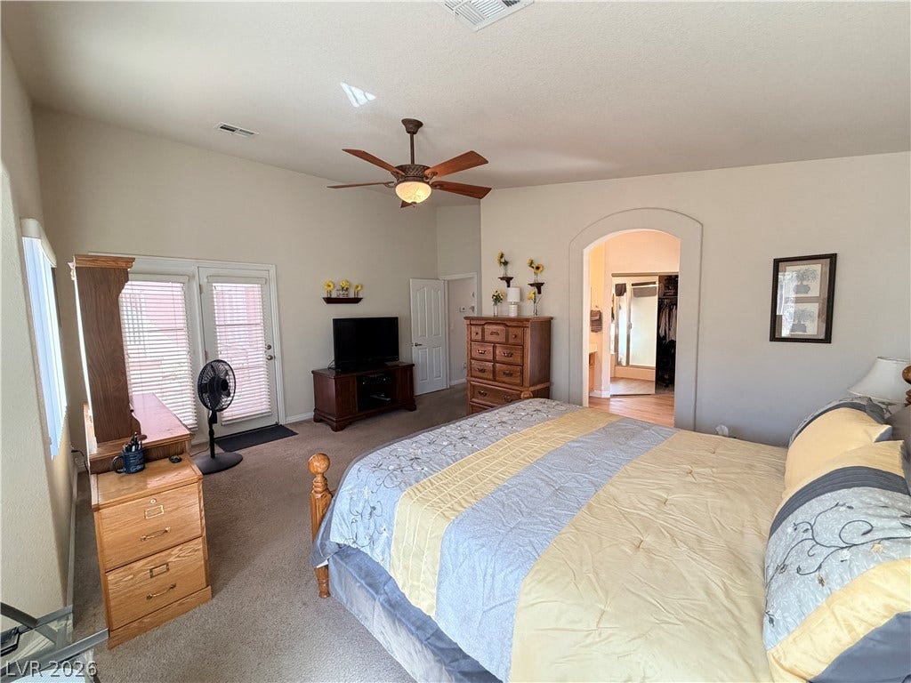 3917 Robin Knot Court, North Las Vegas, NV 89084 An arched doorway leads to the master bath from this bedroom featuring plush carpeting.