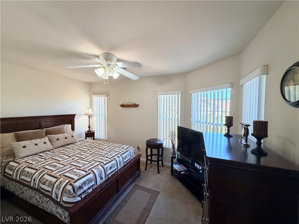 3917 Robin Knot Court, North Las Vegas, NV 89084 Front bedroom has several vertical windows flood the carpeted sleeping area with abundant natural light.