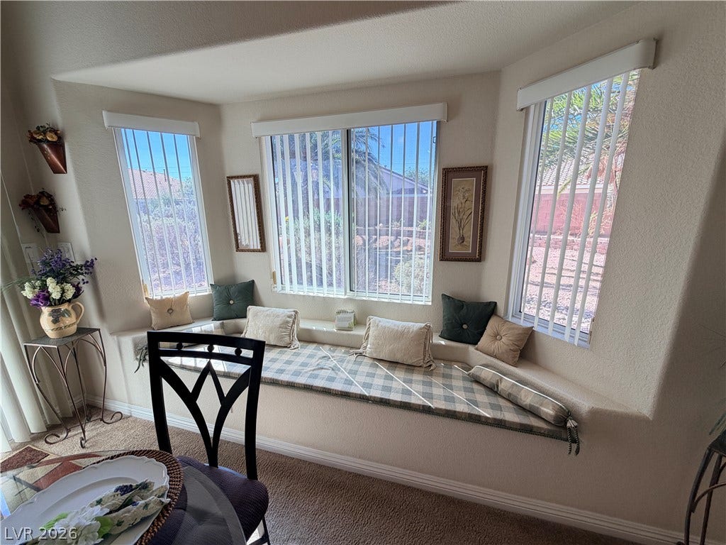 3917 Robin Knot Court, North Las Vegas, NV 89084 A spacious bay window bench offers a cozy architectural focal point alongside plush carpeted flooring.