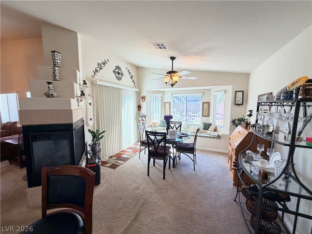 3917 Robin Knot Court, North Las Vegas, NV 89084 An inviting dining area benefits from a cozy fireplace and sun-drenched bay window seating.