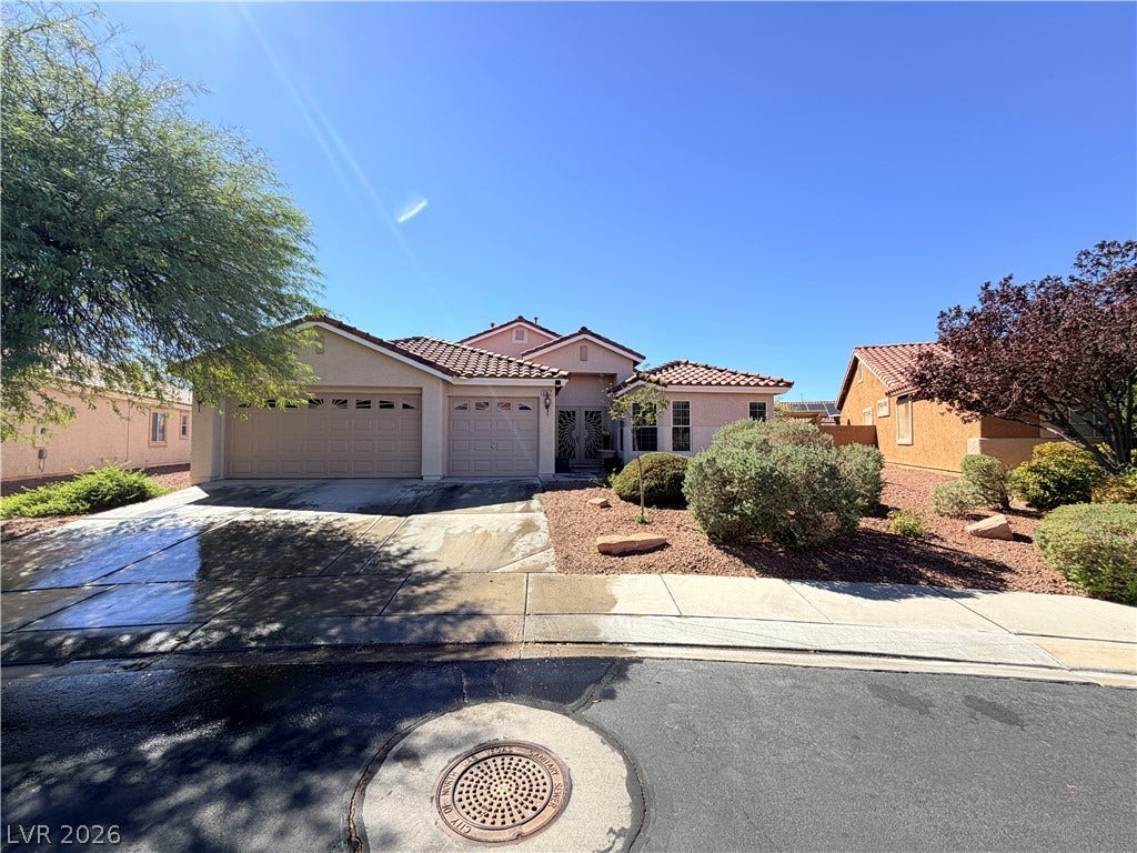 3917 Robin Knot Court, North Las Vegas, NV 89084 A classic stucco exterior and tiled roof define this desert landscape home.
