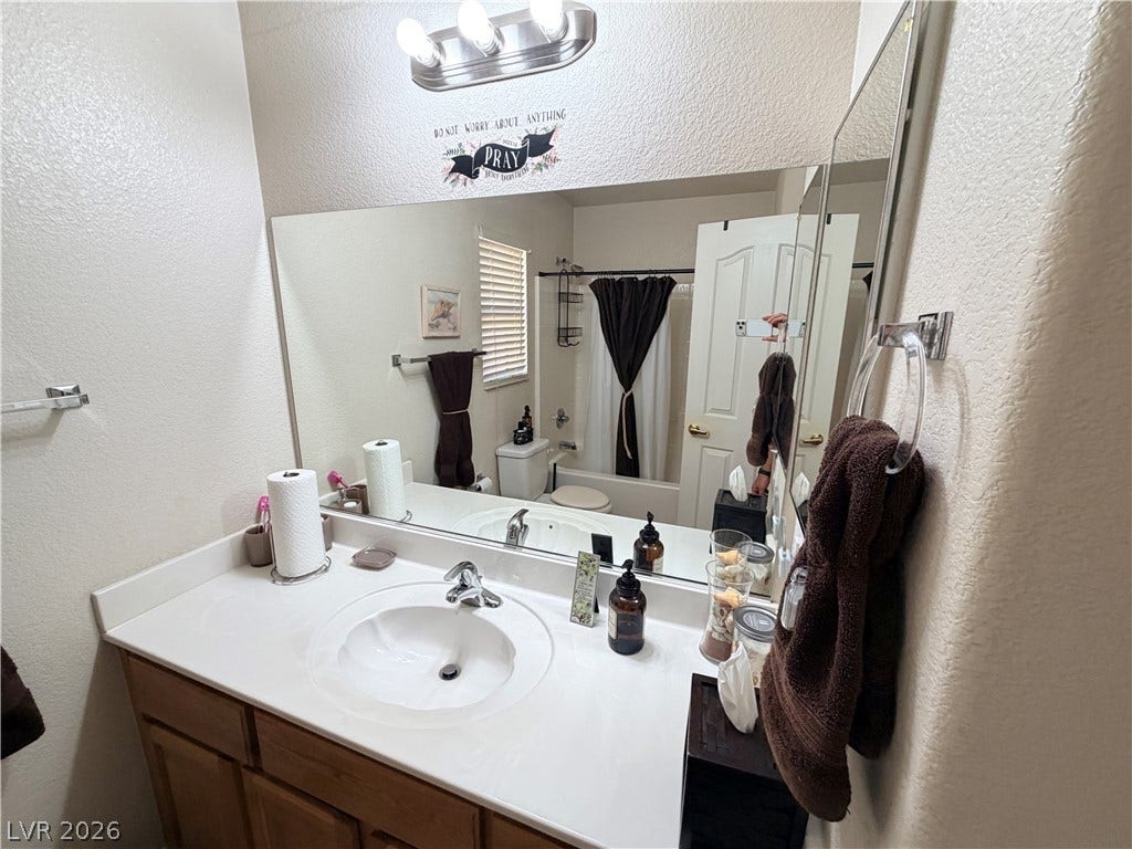 3917 Robin Knot Court, North Las Vegas, NV 89084 An integrated vanity countertop and built-in cabinetry optimize space in this classic bathroom design.