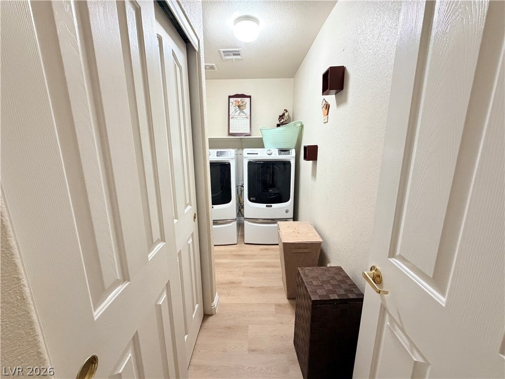 3917 Robin Knot Court, North Las Vegas, NV 89084 Smooth wood-look flooring anchors a dedicated utility space complete with built-in upper shelving.
