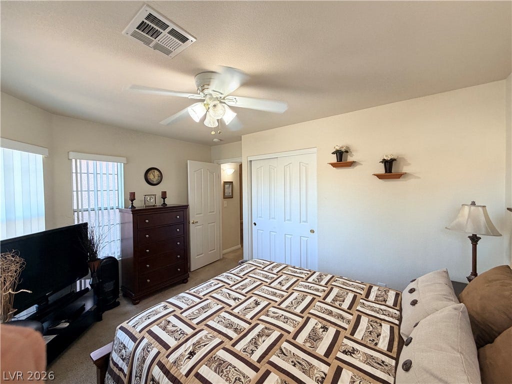 3917 Robin Knot Court, North Las Vegas, NV 89084 Natural light pours across this cozy front bedroom featuring soft carpeting and a spacious closet.