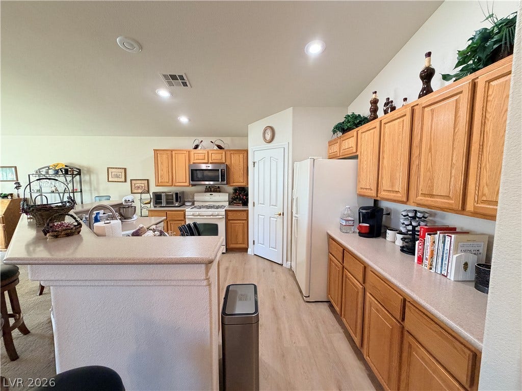 3917 Robin Knot Court, North Las Vegas, NV 89084 Ample wooden cabinetry and resilient LVP flooring define this functional kitchen space.