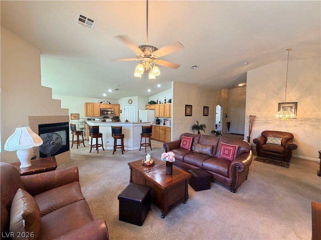 3917 Robin Knot Court, North Las Vegas, NV 89084 An open floorplan seamlessly connects the carpeted living area to the kitchen and dining spaces.