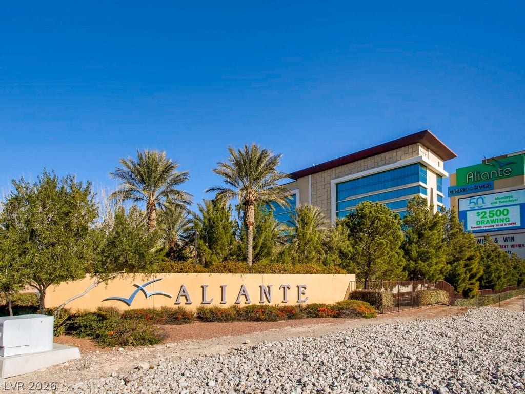 3917 Robin Knot Court, North Las Vegas, NV 89084 Aliante neighborhood entry monument stands before manicured desert landscaping and towering palm trees.