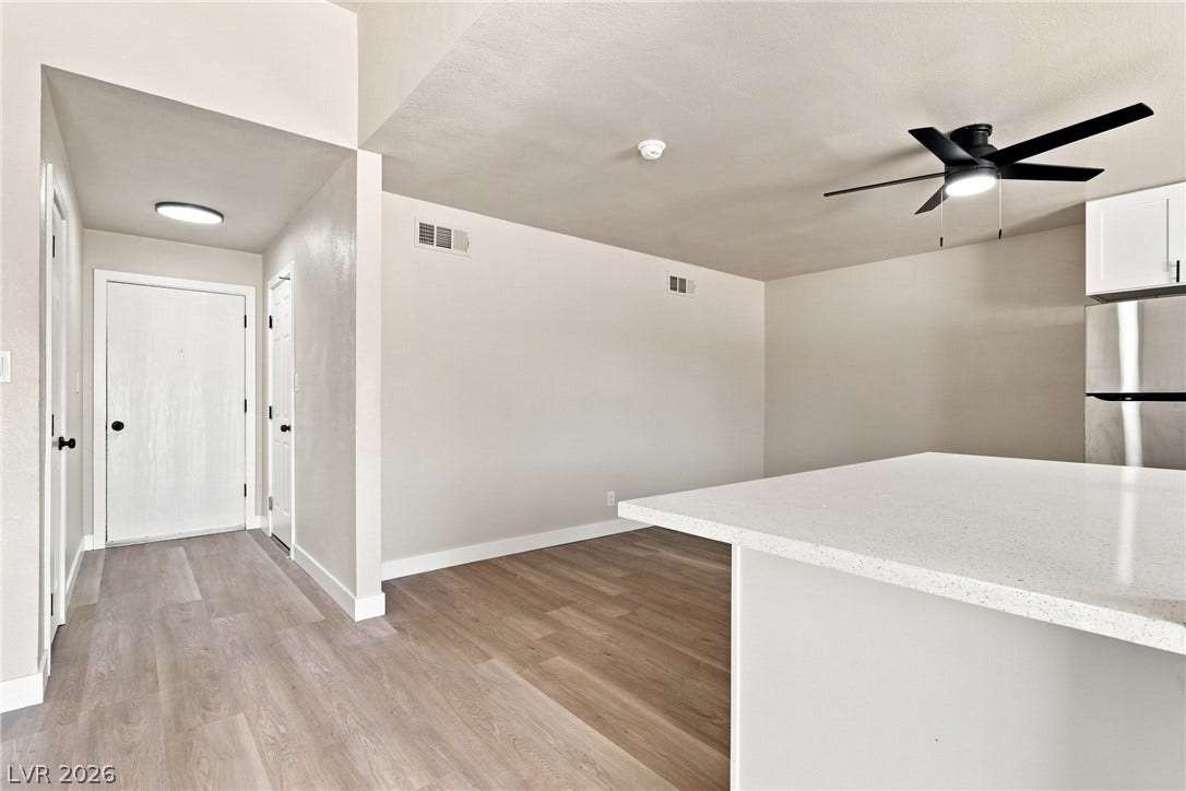 Gleaming wood-look flooring flows from the welcoming entry hall directly into the modern open kitchen.