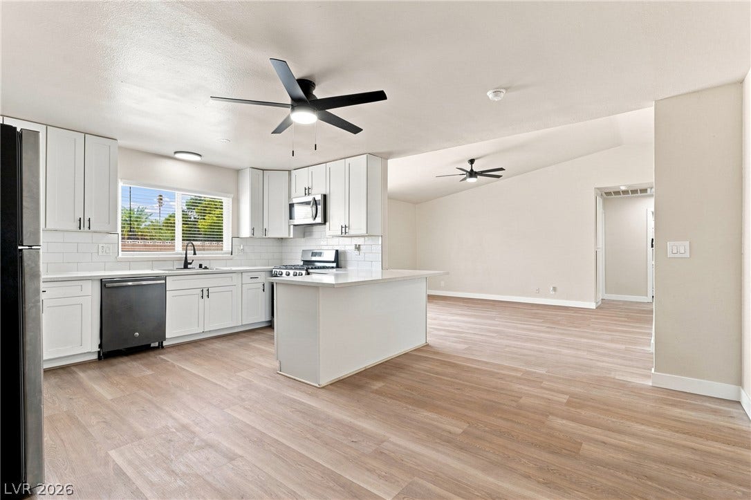 An open floor plan seamlessly connects a modern kitchen to the adjacent living space.