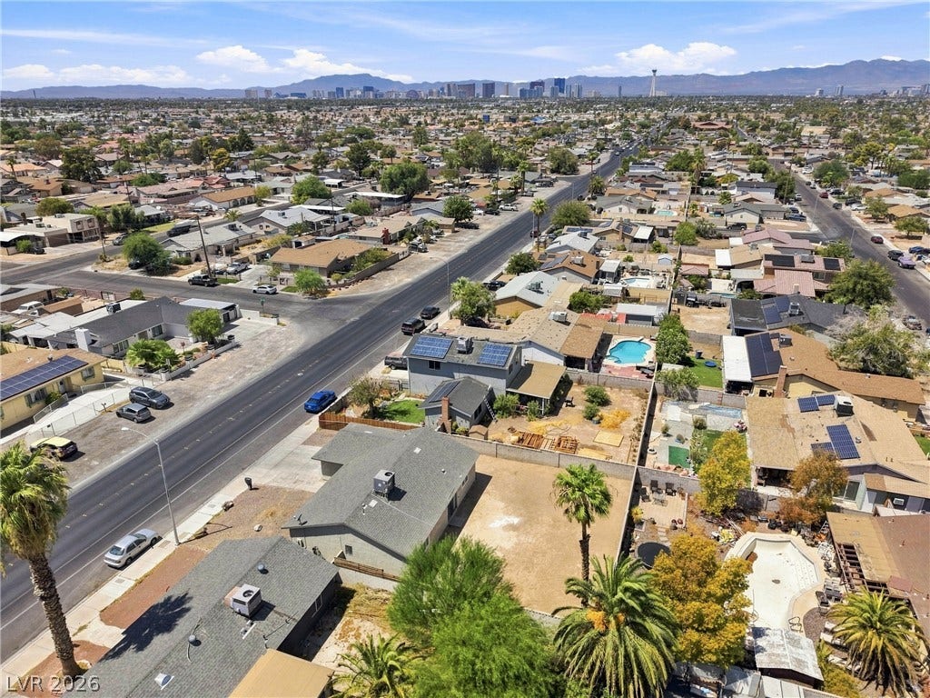 Distant city skyline views and mountain backdrops frame this established neighborhood setting.