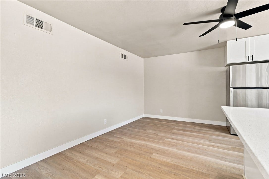 Smooth wood-style flooring runs throughout this versatile dining area adjacent to the kitchen.