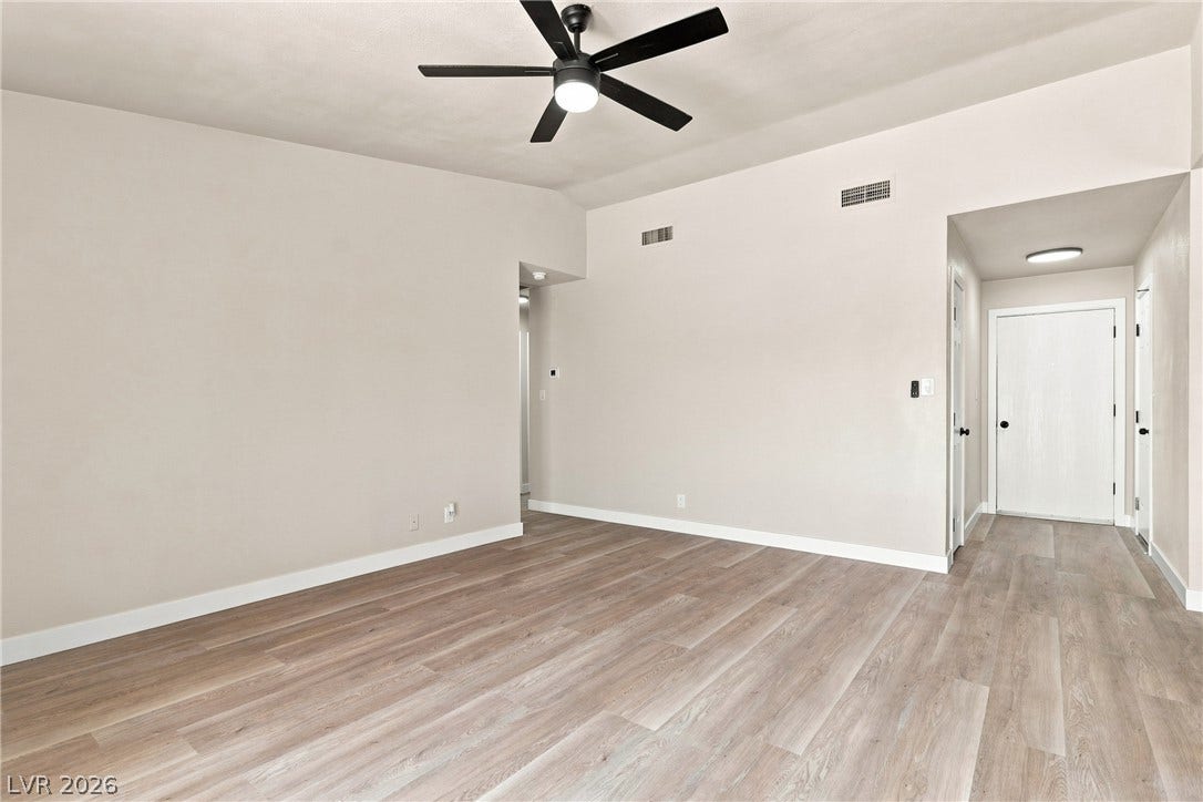 Smooth wood-style flooring runs throughout this open space with a neutral interior finish.