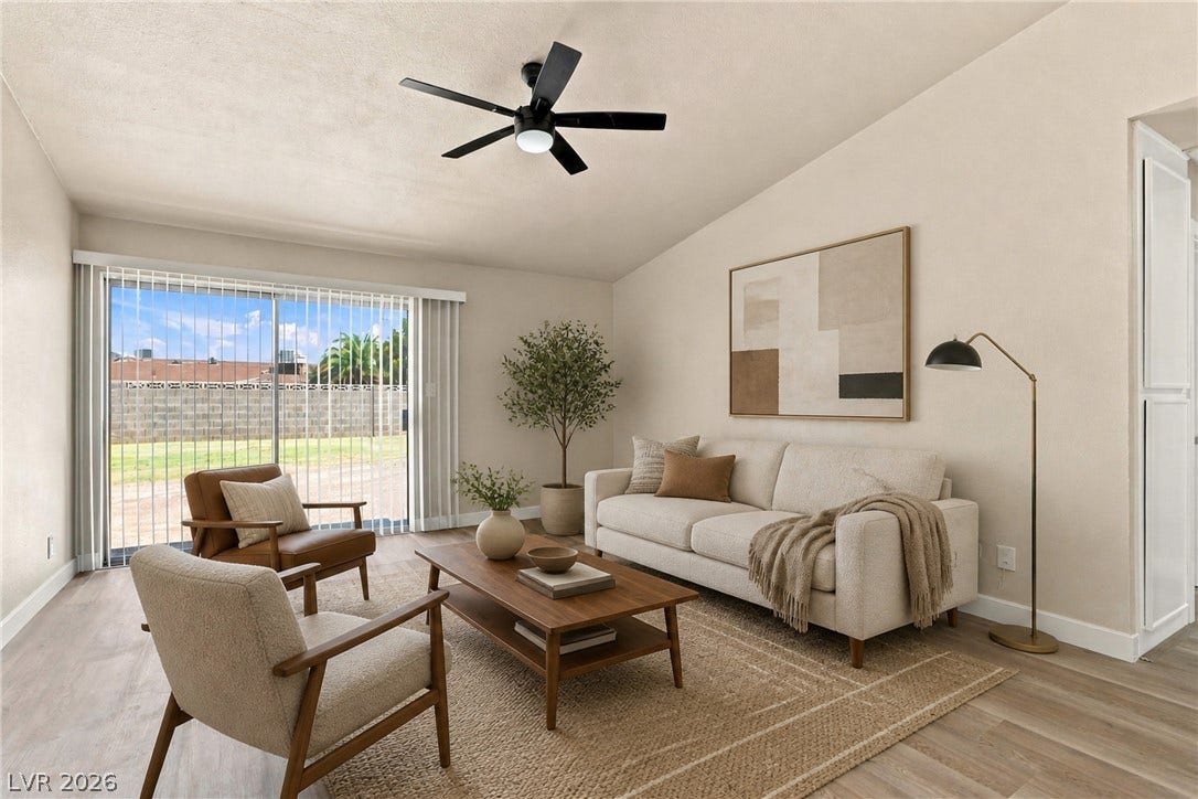 **Virtually Staged**  A sliding glass door opens to the outdoors from this living space with wood flooring.