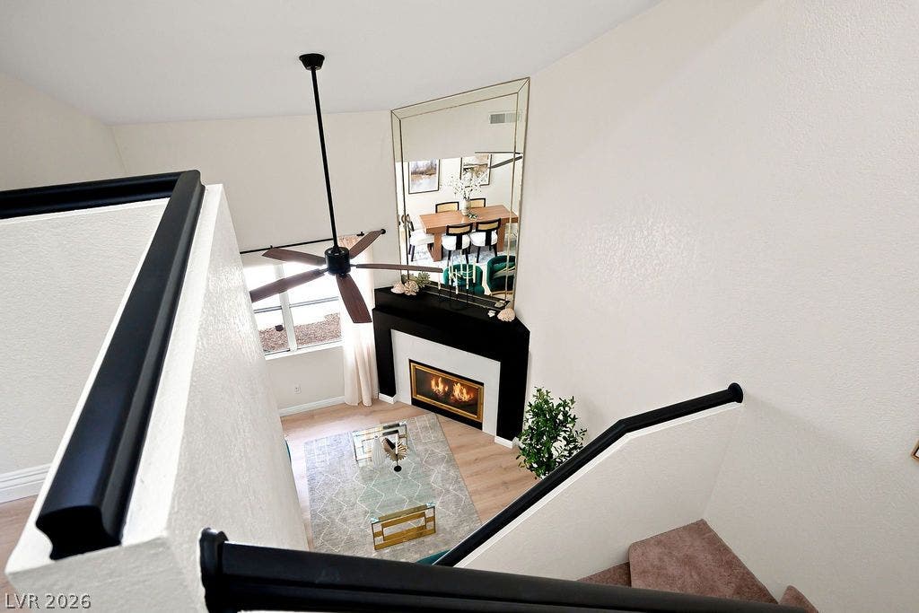 6250 W Flamingo Road, #62, Las Vegas, NV 89103 Stunning overhead view of the living room featuring high ceilings and a cozy fireplace.