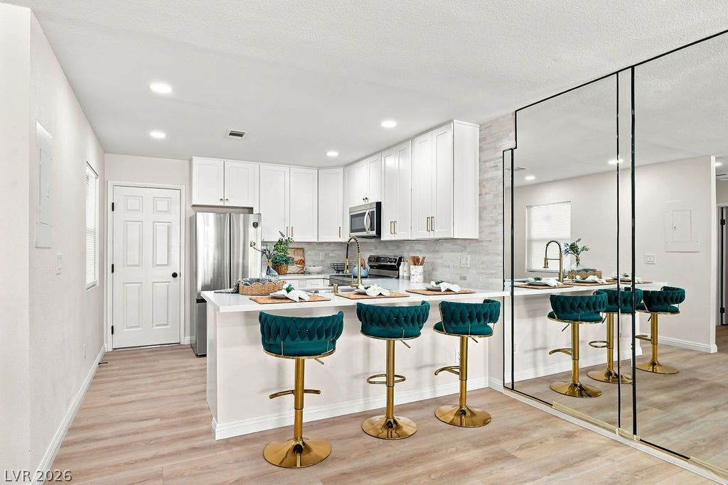 6250 W Flamingo Road, #62, Las Vegas, NV 89103 Gleaming stone countertops and matching cabinetry define this modern kitchen spaces.