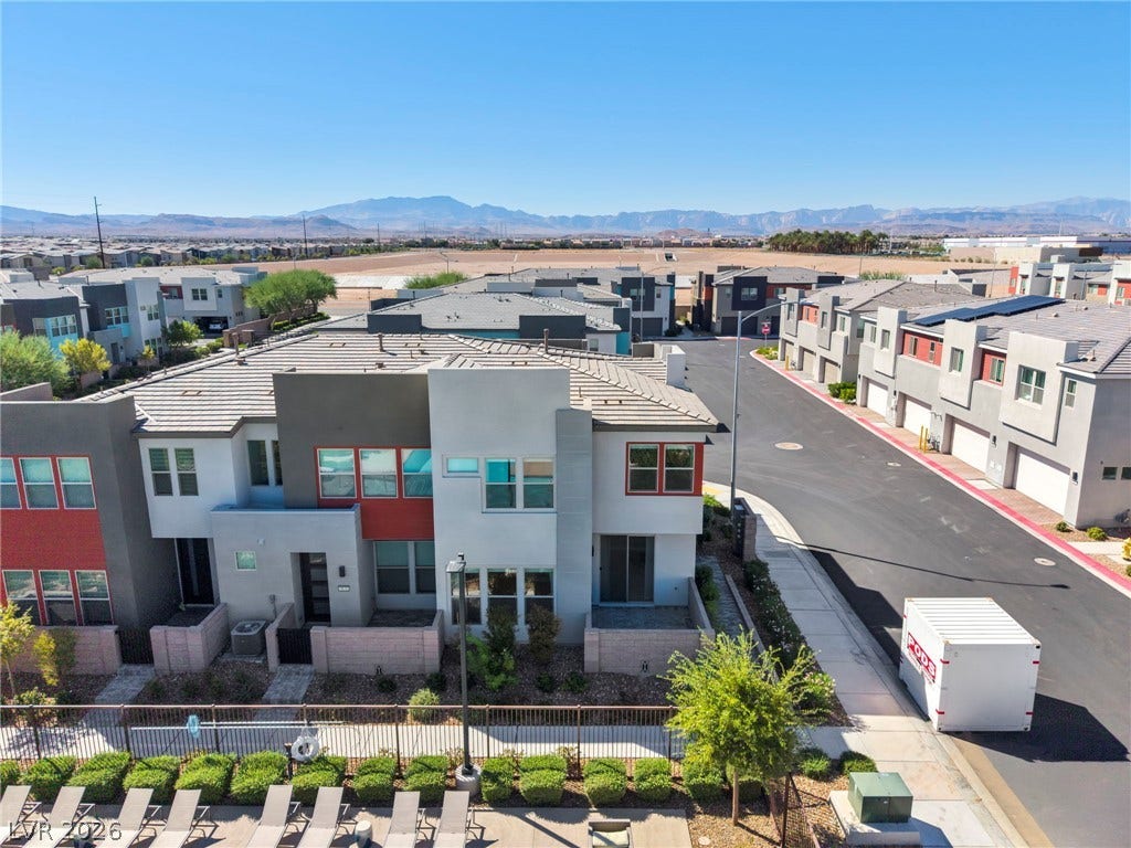 9826 Canyon Sage Street, Las Vegas, NV 89141 Striking contemporary townhomes sit nestled against a majestic backdrop of distant desert mountains.