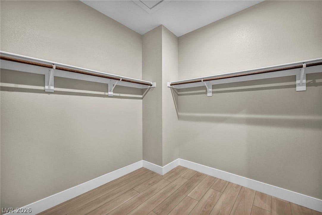 9826 Canyon Sage Street, Las Vegas, NV 89141 Generous closet space features wood-look flooring and built-in shelving with hanging rods.
