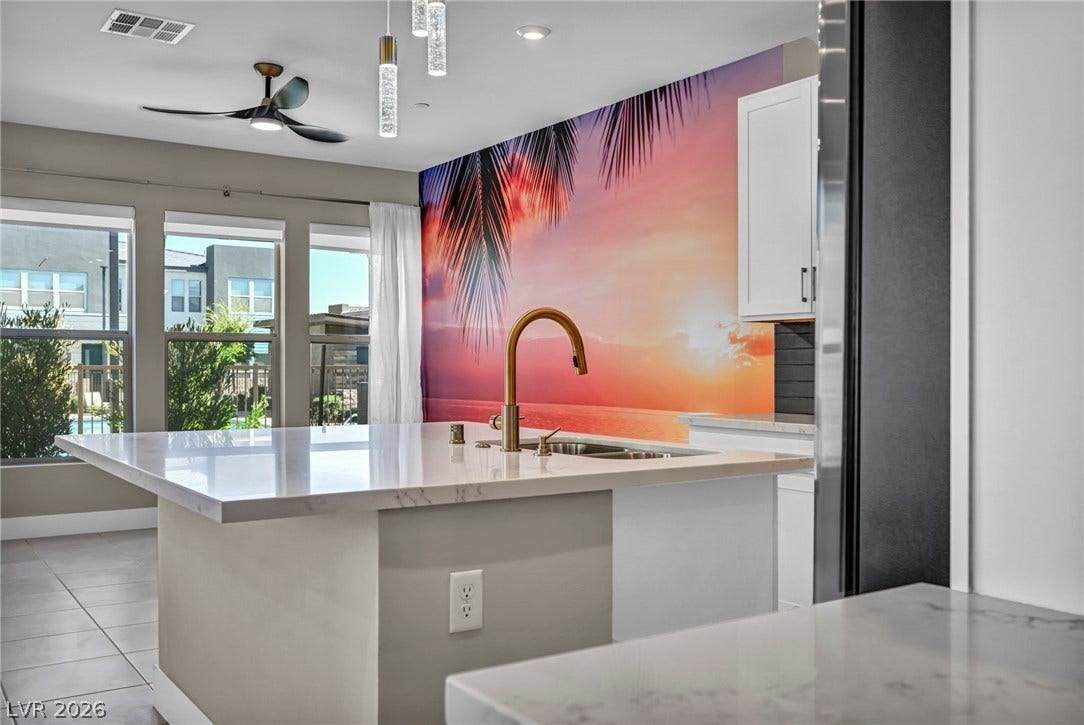 9826 Canyon Sage Street, Las Vegas, NV 89141 Lustrous stone countertops and a spacious central island anchor this contemporary culinary space.