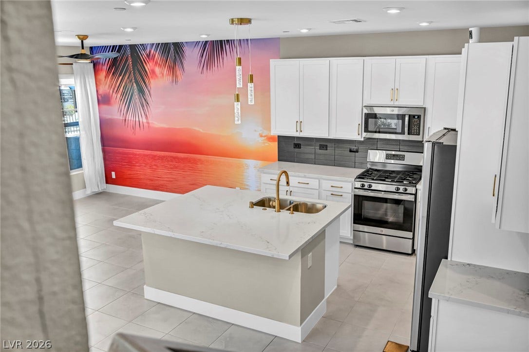 9826 Canyon Sage Street, Las Vegas, NV 89141 An open kitchen reveals stone countertops and a spacious central island over tiled flooring.