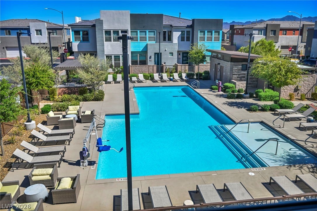 9826 Canyon Sage Street, Las Vegas, NV 89141 A sparkling community swimming pool serves as a central hub within this modern residential development.