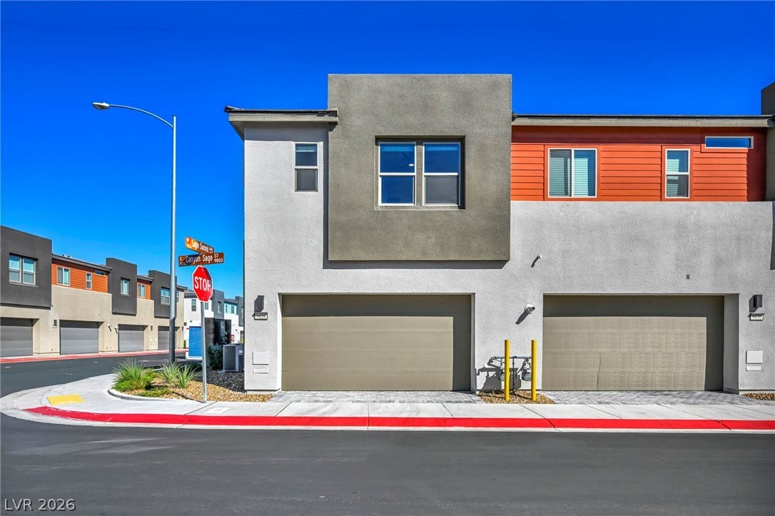 9826 Canyon Sage Street, Las Vegas, NV 89141 Clean lines and multi-textured facades define this modern townhouse exterior featuring attached two-car garages.