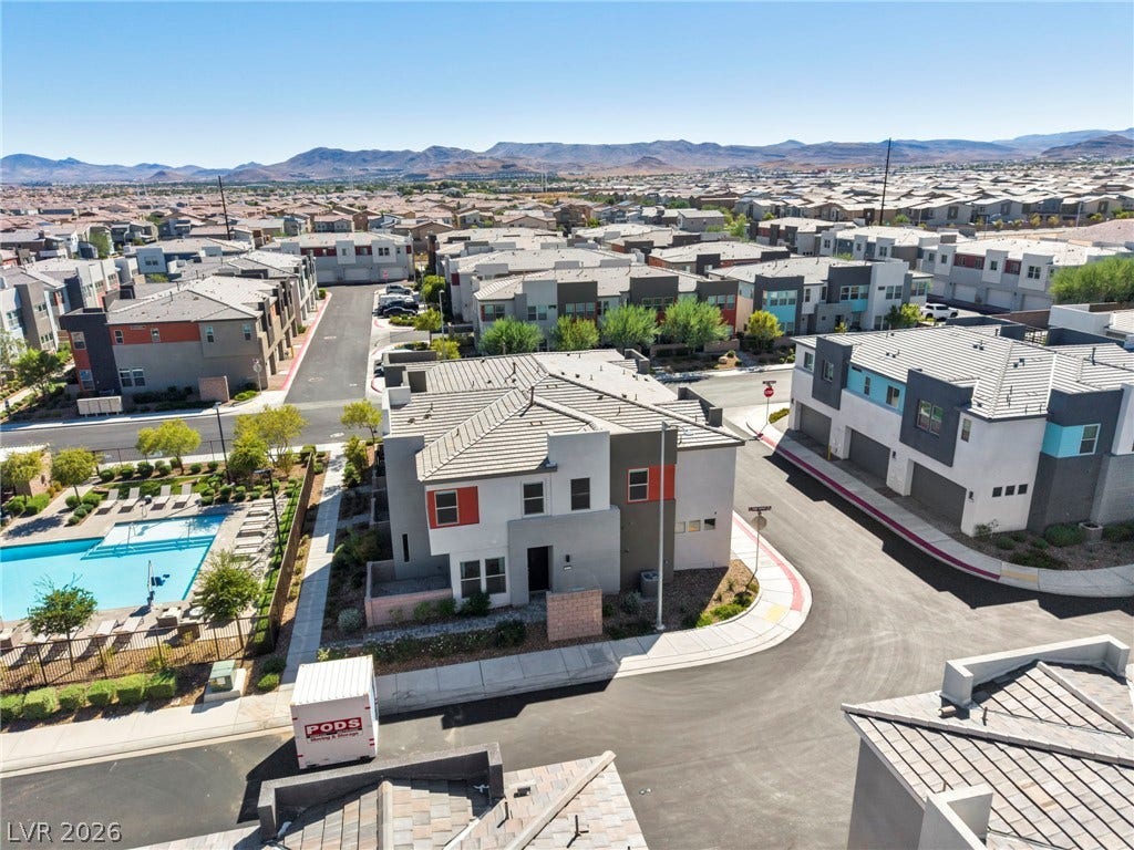 9826 Canyon Sage Street, Las Vegas, NV 89141 Sweeping mountain vistas frame a modern community featuring clean architectural lines and shared amenities.