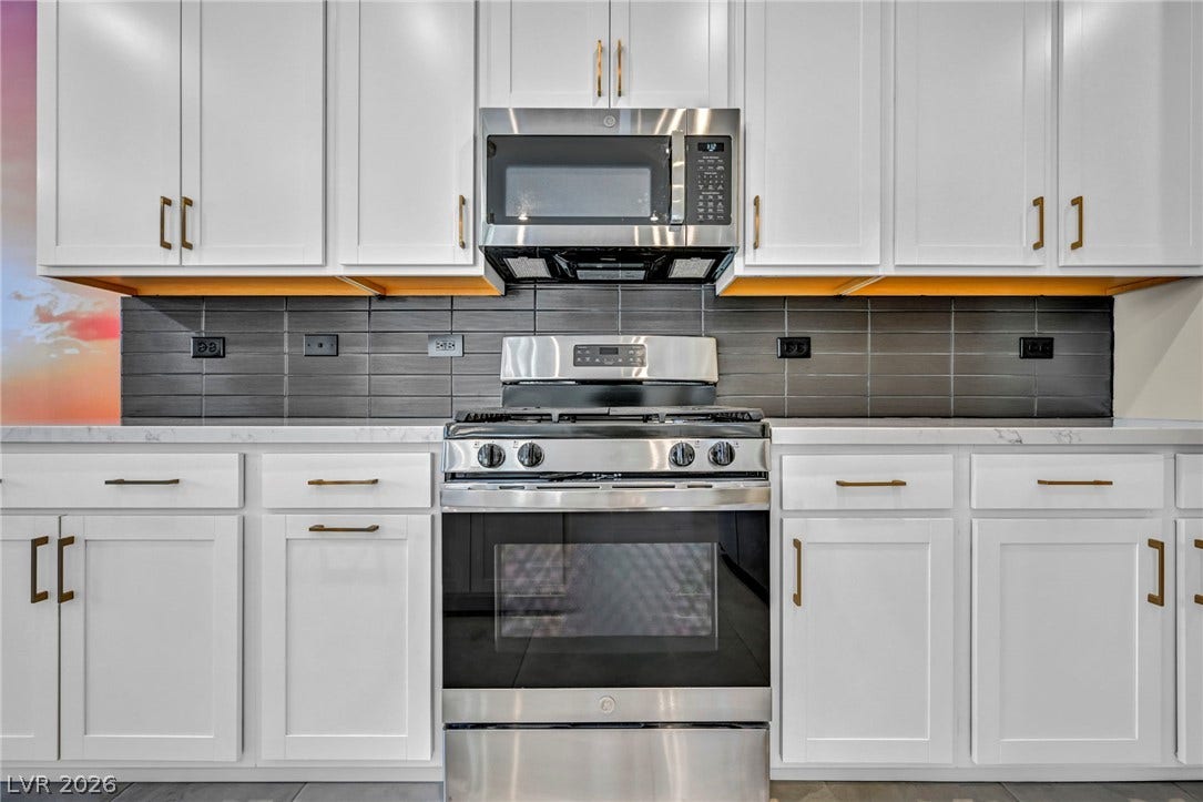 9826 Canyon Sage Street, Las Vegas, NV 89141 Sleek modern cabinetry and integrated stainless appliances define this clean culinary space.