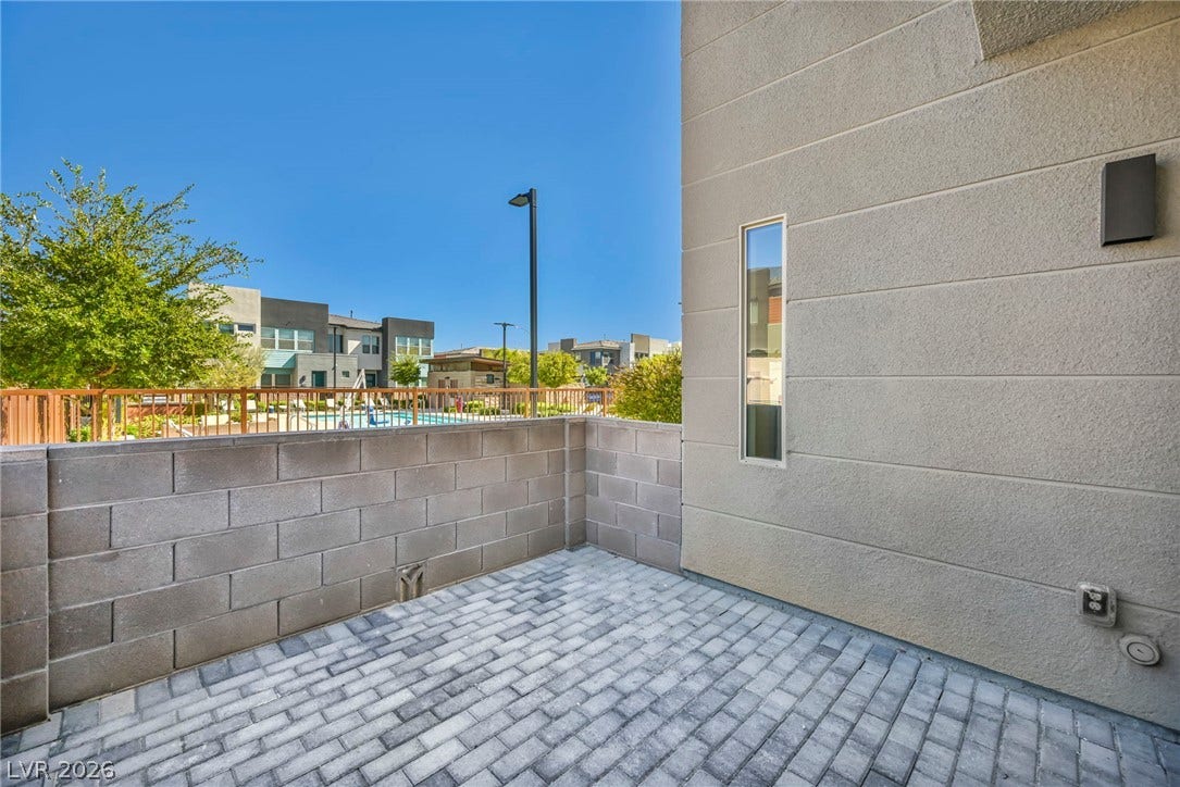 9826 Canyon Sage Street, Las Vegas, NV 89141 An inviting private patio features durable brick pavers enclosed by block walls under clear blue skies.